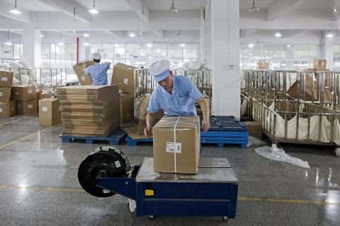 Worker packing goods for shipment